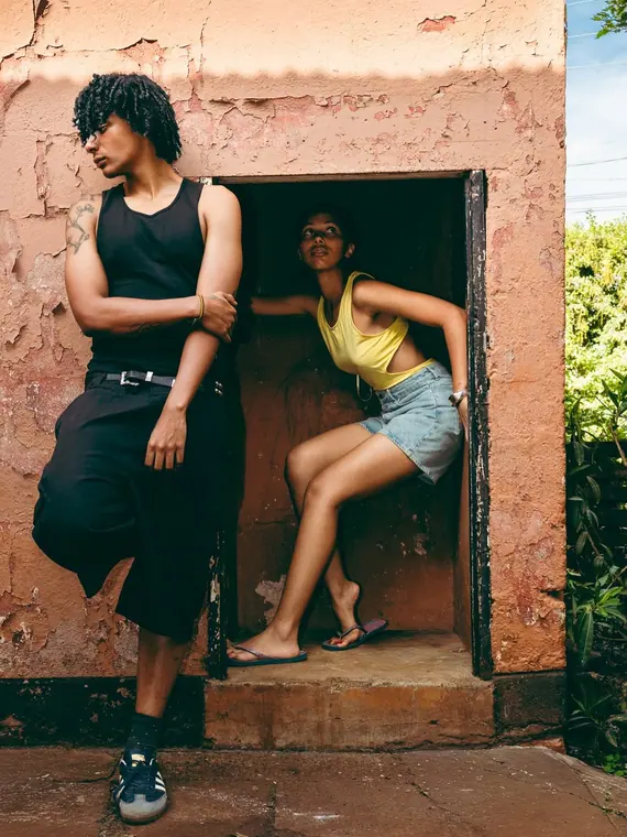 Styled portrait against a painted wall in Kibera, from the Still Here series