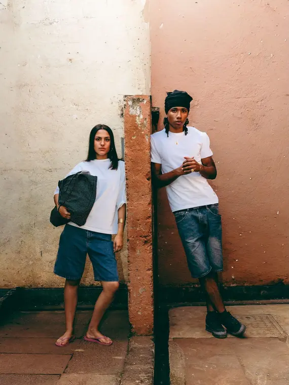 Styled portrait against a painted wall in Kibera, from the Still Here series