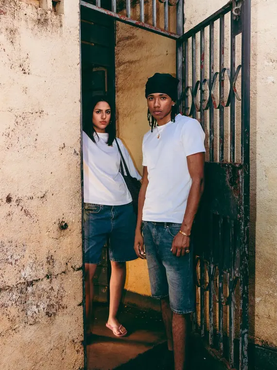Styled portrait against a painted wall in Kibera, from the Still Here series