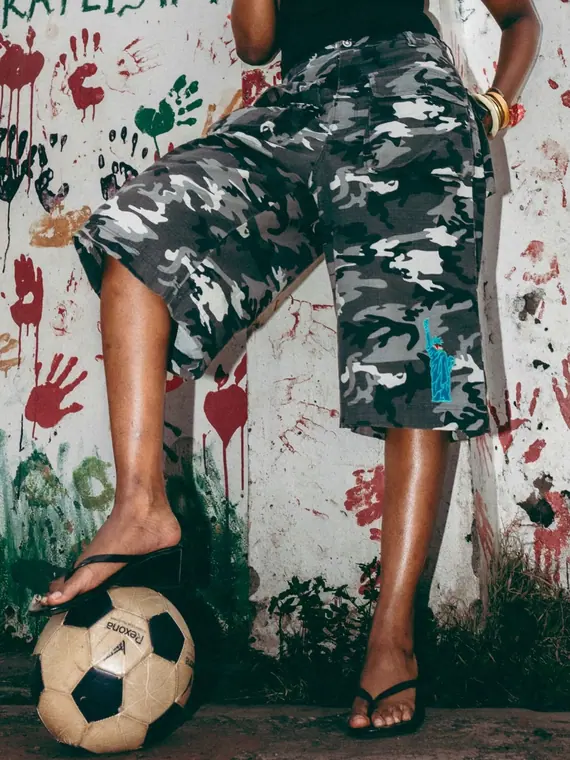 Styled portrait against a painted wall in Kibera, from the Still Here series