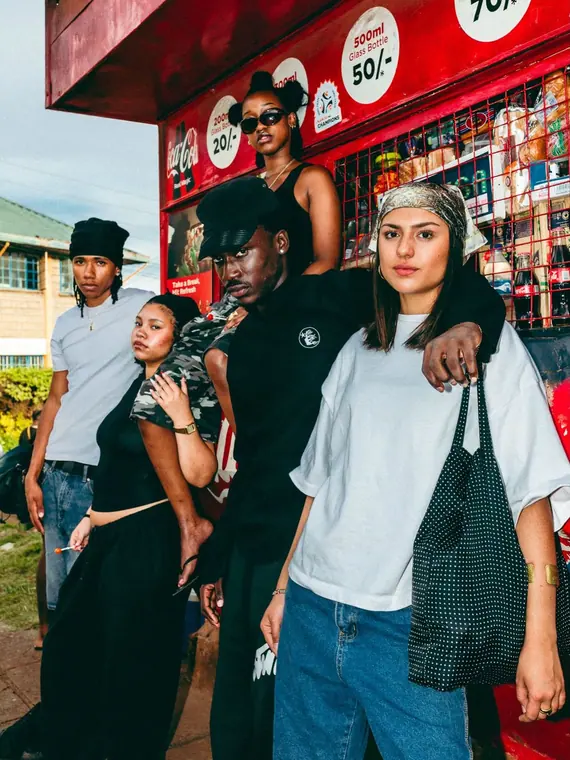 Styled portrait against a painted wall in Kibera, from the Still Here series