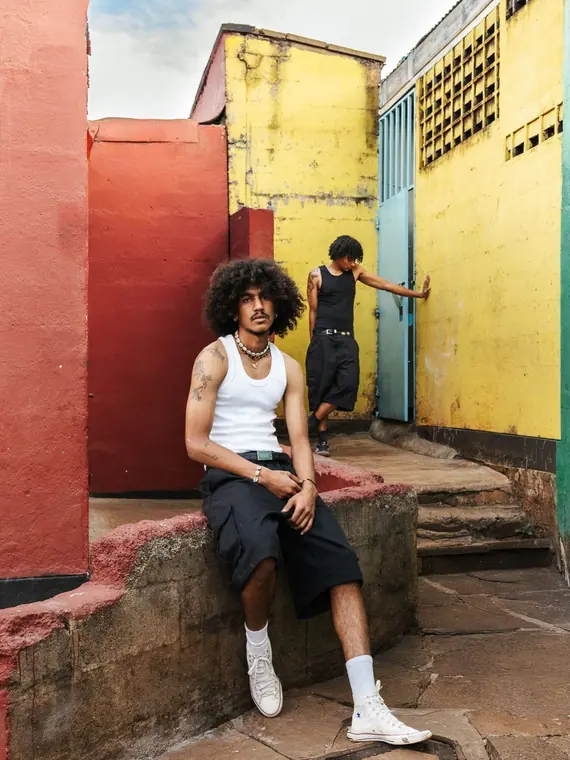 Styled portrait against a painted wall in Kibera, from the Still Here series