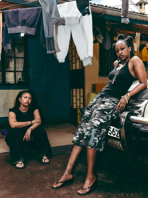 Styled portrait against a painted wall in Kibera, from the Still Here series