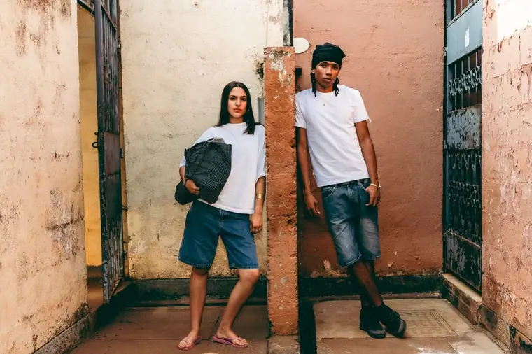 Styled portrait against a painted wall in Kibera, from the Still Here series