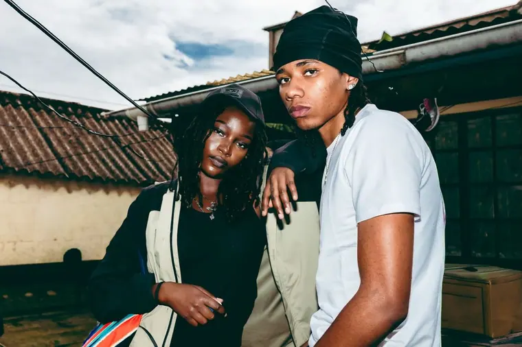 Styled portrait against a painted wall in Kibera, from the Still Here series