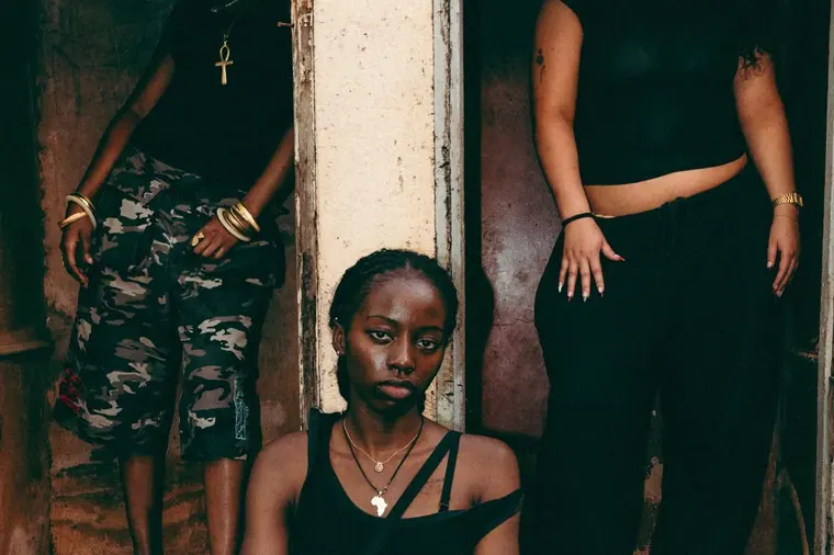 Styled portrait against a painted wall in Kibera, from the Still Here series