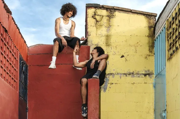 Styled portrait against a painted wall in Kibera, from the Still Here series