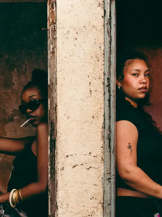 Styled portrait against a painted wall in Kibera, from the Still Here series